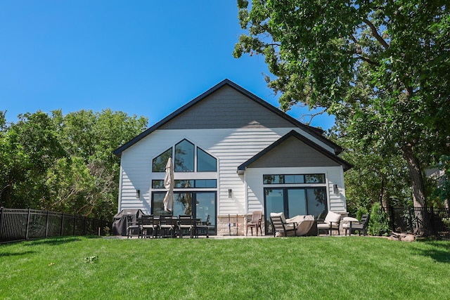 back of house with a patio area and a lawn