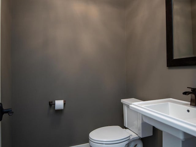 bathroom featuring toilet and sink