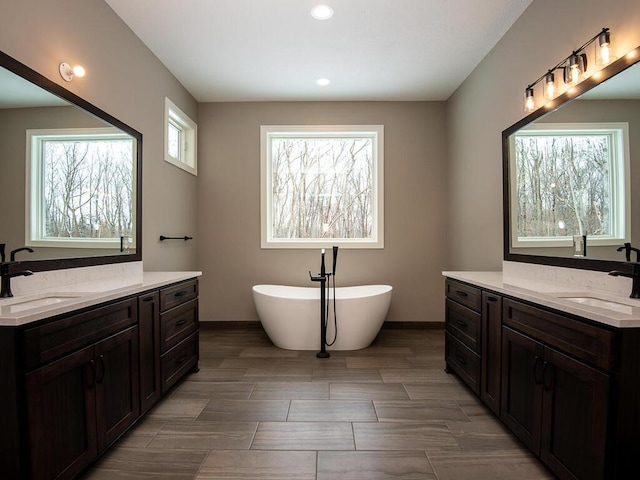 bathroom with vanity and a tub to relax in