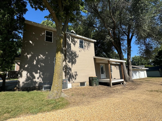 417 Pine St, Saint Peter, MN 56082 - exterior space featuring a lawn, central air condition unit, and a garage