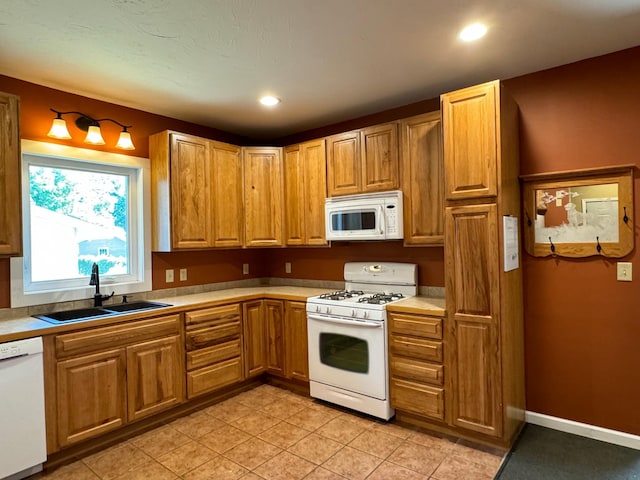 417 Pine St, Saint Peter, MN 56082 - kitchen featuring light countertops, brown cabinets, a sink, and white appliances