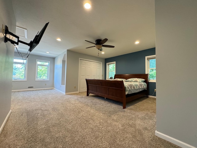 unfurnished bedroom with carpet flooring, ceiling fan, and a closet