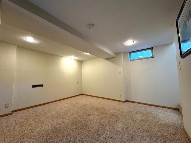 basement featuring light carpet