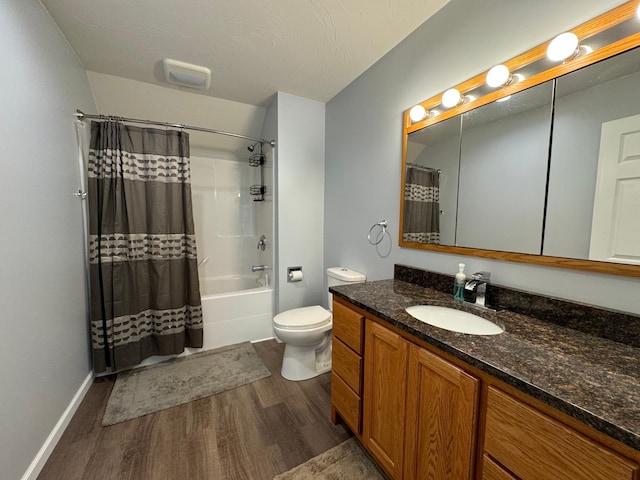 full bathroom featuring a textured ceiling, vanity, shower / tub combo with curtain, wood-type flooring, and toilet