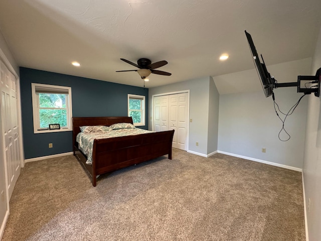 carpeted bedroom with ceiling fan and a closet