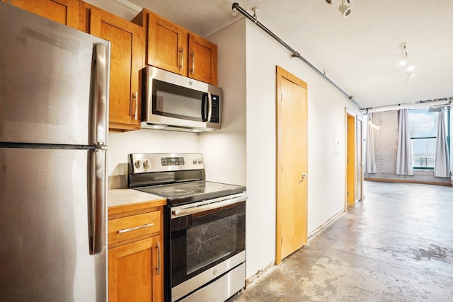 kitchen featuring appliances with stainless steel finishes and a textured ceiling