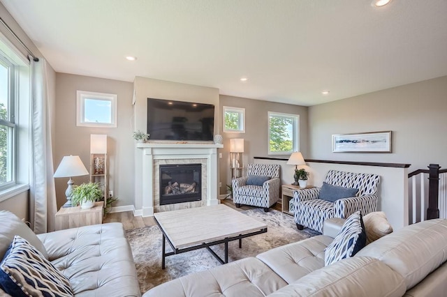 living room with light hardwood / wood-style floors and a tile fireplace