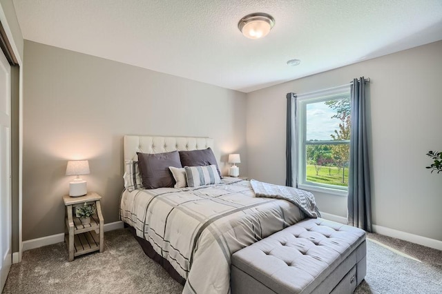 bedroom with a textured ceiling and carpet flooring