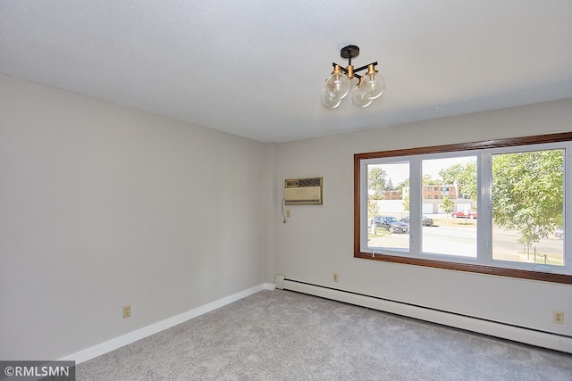 carpeted spare room with a textured ceiling, an AC wall unit, an inviting chandelier, and a baseboard heating unit