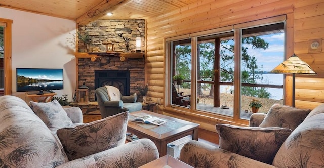 living room featuring beamed ceiling, wood ceiling, a stone fireplace, wood finished floors, and rustic walls