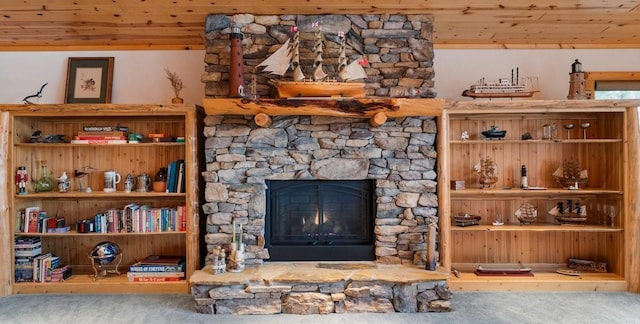 carpeted living room with a fireplace and wood ceiling