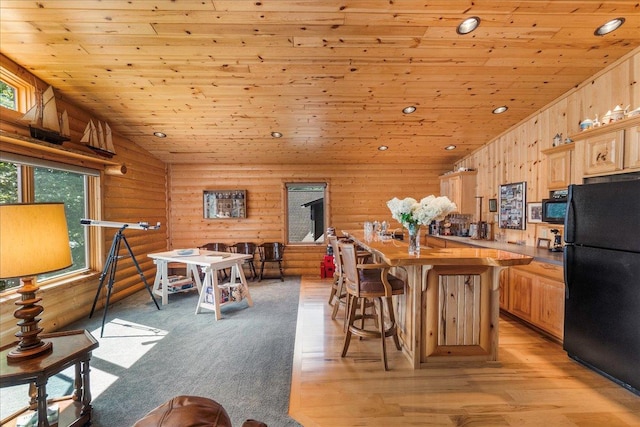 kitchen with black appliances, wood ceiling, light brown cabinets, and lofted ceiling