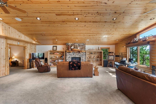 carpeted living area featuring a stone fireplace, wooden ceiling, a ceiling fan, and vaulted ceiling