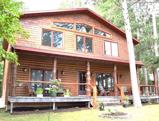 rear view of house featuring covered porch