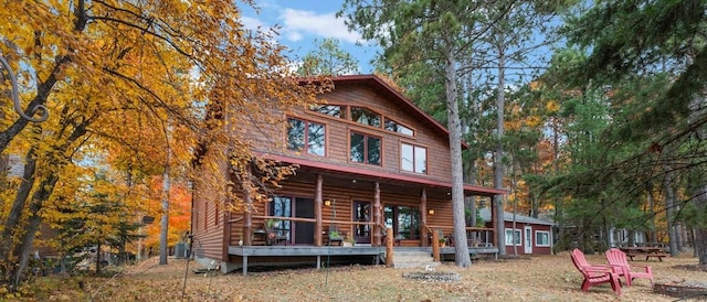 rear view of property with a porch and central AC