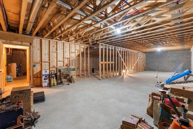 unfinished basement featuring water heater