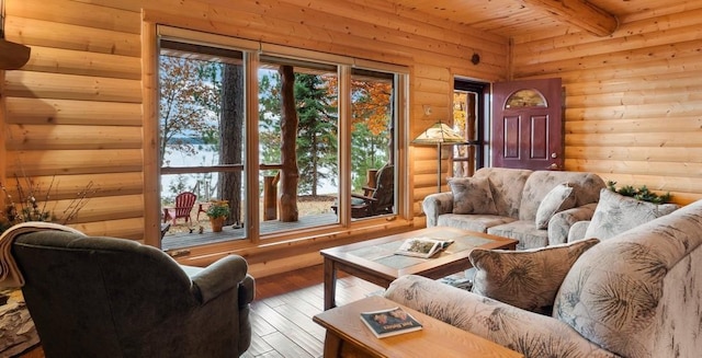 living area featuring log walls, hardwood / wood-style flooring, wood walls, wooden ceiling, and beamed ceiling