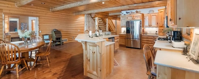 kitchen featuring visible vents, beam ceiling, stainless steel appliances, light countertops, and wood ceiling