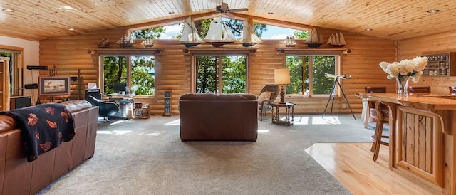 living area featuring rustic walls, wooden ceiling, ceiling fan, and vaulted ceiling