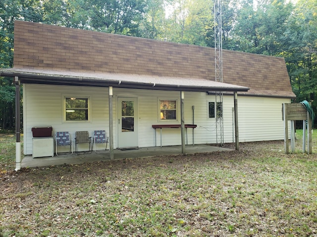 view of front facade with a patio and a front lawn