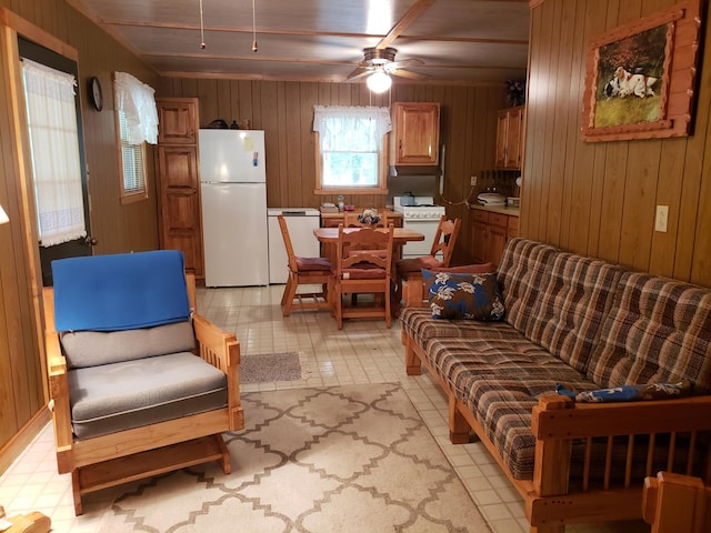 living room featuring ceiling fan, wooden walls, and wooden ceiling