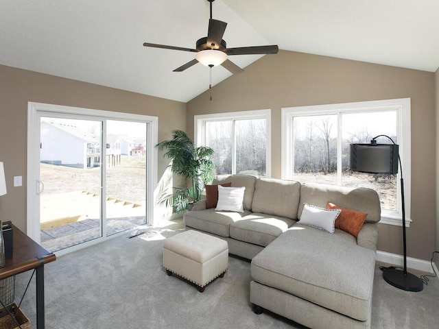 living room with lofted ceiling, ceiling fan, plenty of natural light, and carpet