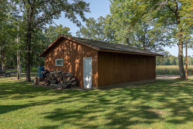 view of outdoor structure featuring a lawn