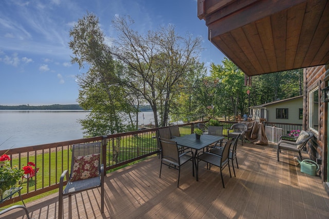 wooden terrace with a lawn and a water view