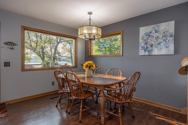 dining room featuring dark wood-type flooring and a notable chandelier