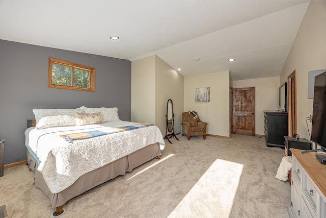 bedroom featuring lofted ceiling and light colored carpet