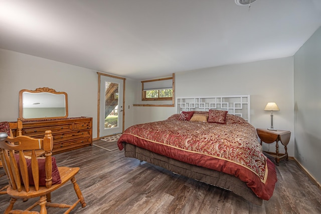 bedroom featuring access to outside and dark hardwood / wood-style flooring