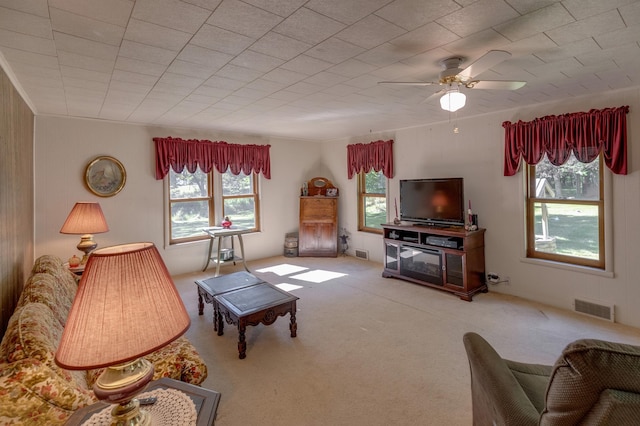 living room with ceiling fan, a healthy amount of sunlight, and carpet floors