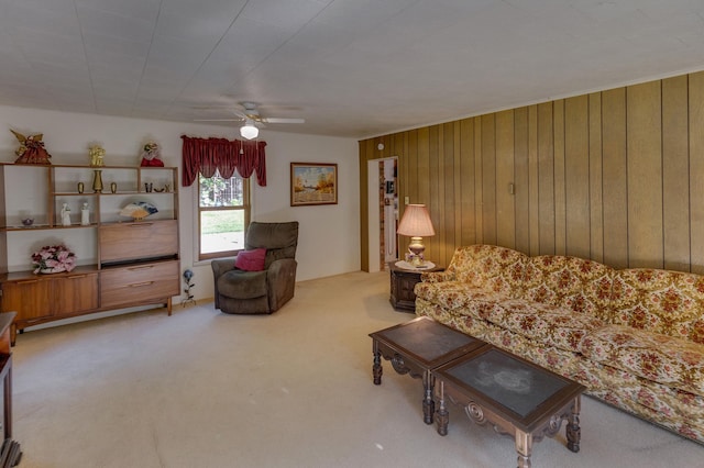 living room with light carpet, ceiling fan, and wood walls