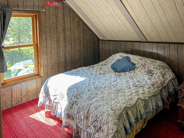 bedroom featuring vaulted ceiling and wood walls