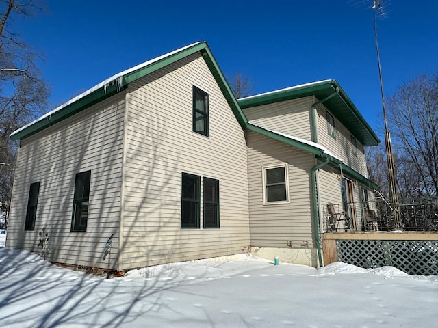 view of snow covered exterior featuring a deck