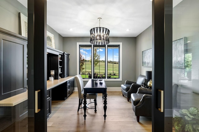 living room with a chandelier and light hardwood / wood-style floors