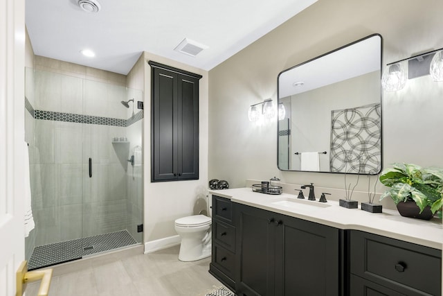 bathroom with an enclosed shower, tile patterned flooring, toilet, and vanity