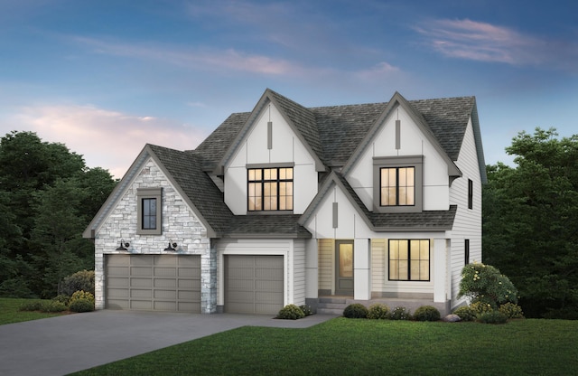 view of front of house featuring a garage and a front lawn