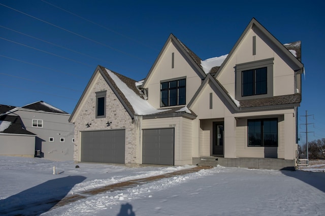 view of front facade featuring an attached garage and stone siding