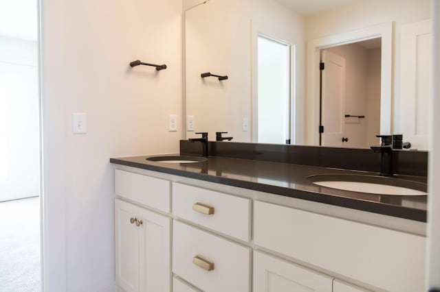 full bath featuring double vanity and a sink