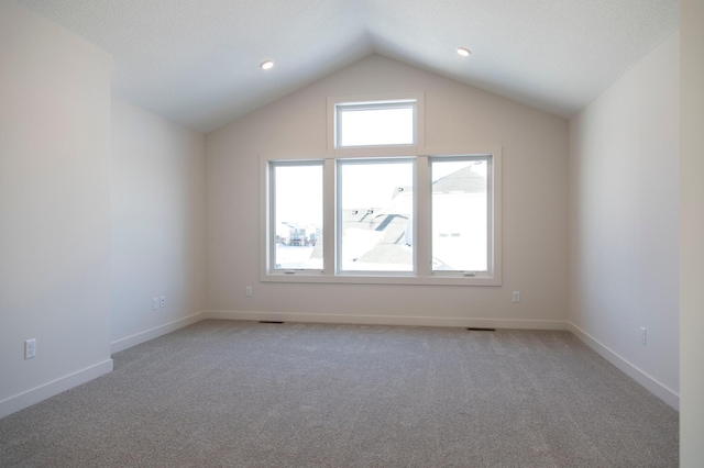 bonus room featuring vaulted ceiling, baseboards, and light colored carpet