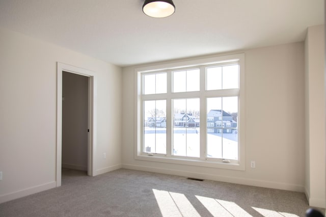 15170 110th Ave N, Dayton, MN 55369 - empty room with visible vents, baseboards, plenty of natural light, and light carpet