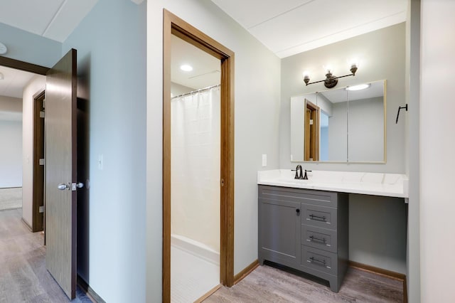 bathroom with vanity, hardwood / wood-style floors, and curtained shower