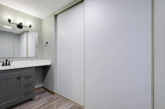 bathroom with vanity and hardwood / wood-style floors