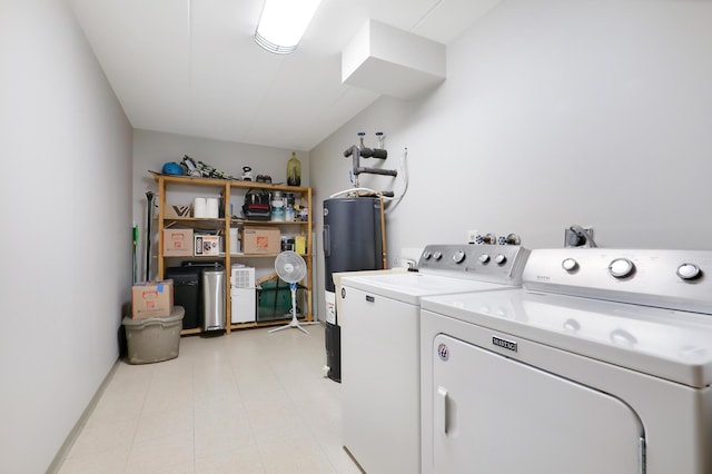 washroom with washing machine and dryer and electric water heater