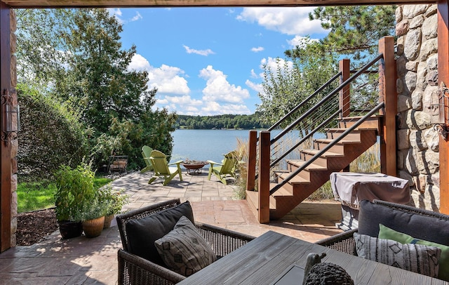 view of patio featuring a water view and outdoor lounge area