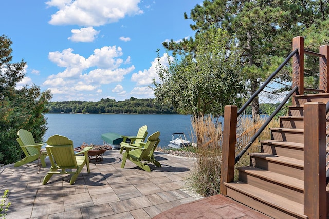 view of patio / terrace with a water view and an outdoor fire pit