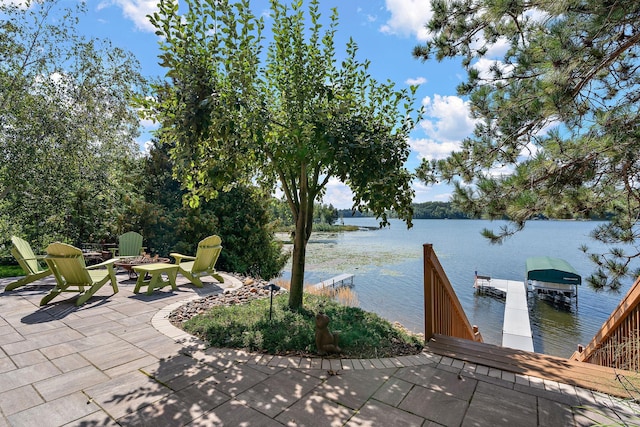 view of patio / terrace featuring a boat dock and a water view