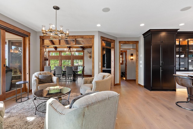 living room featuring light hardwood / wood-style flooring and a chandelier