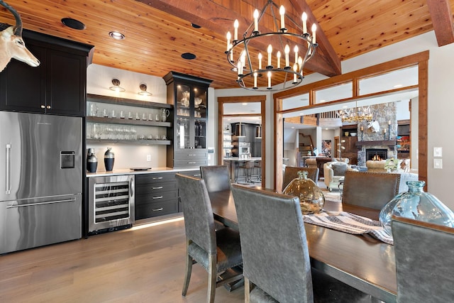 dining space with light hardwood / wood-style flooring, bar, vaulted ceiling with beams, wooden ceiling, and beverage cooler